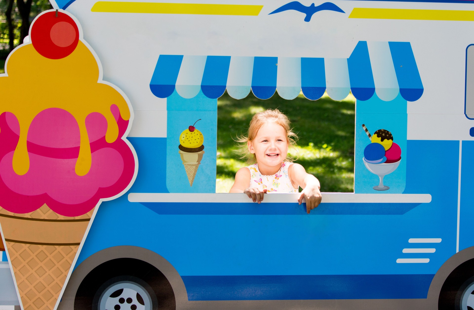 Child pretends to sell ice cream from an ice cream van
